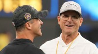 Baltimore Ravens coach John Harbaugh with brother and Los Angeles Chargers coach Jim Harbaugh before the game at SoFi Stadium.