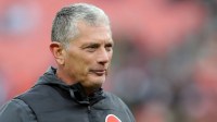 Cleveland Browns defensive coordinator Jim Schwartz watches the team warm up before an NFL football game at Huntington Bank Field
