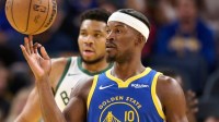 Golden State Warriors forward Jimmy Butler III (10) spins the ball on his finger and Milwaukee Bucks forward Giannis Antetokounmpo (34) looks on during a stoppage of play in the third quarter at Chase Center.