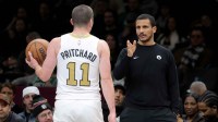Boston Celtics head coach Joe Mazzulla talks to guard Payton Pritchard (11) during the first quarter against the Brooklyn Nets at Barclays Center.
