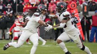 Houston Texans quarterback C.J. Stroud (7) hands off the ball to running back Joe Mixon (28) against the Kansas City Chiefs during the second quarter of a 2025 AFC divisional round game at GEHA Field at Arrowhead Stadium.