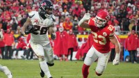 Houston Texans running back Joe Mixon (28) runs the ball as Kansas City Chiefs linebacker Drue Tranquill (23) defends during the second half of a 2025 AFC divisional round game at GEHA Field at Arrowhead Stadium