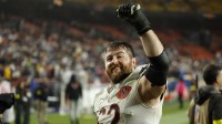 Chicago Bears guard Joe Thuney (62) celebrates while leaving the field after the game against the Washington Commanders at Northwest Stadium.