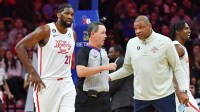 ;Philadelphia 76ers head coach Doc Rivers and center Joel Embiid (21) question referee Matt Boland (18) against the Oklahoma City Thunder during the first quarter at Wells Fargo Center.