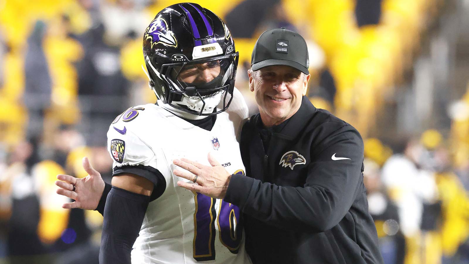 Baltimore Ravens head coach John Harbaugh (right) greets wide receiver Tylan Wallace (16) before the game against the Pittsburgh Steelers at Acrisure Stadium.