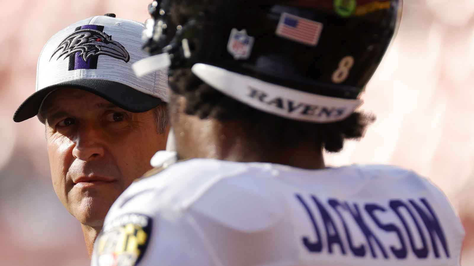 Baltimore Ravens head coach John Harbaugh (L) talks with Ravens quarterback Lamar Jackson (8) during warmups prior to their game against the Washington Football Team at FedExField.