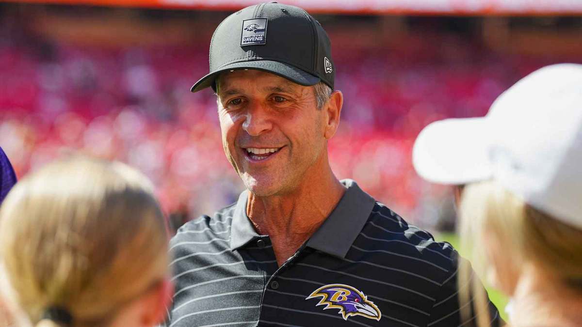 Baltimore Ravens head coach John Harbaugh talks to fans prior to a game against the Kansas City Chiefs at GEHA Field at Arrowhead Stadium.