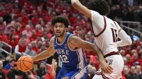 Duke Blue Devils forward Cameron Boozer (12) drives to the basket against Louisville Cardinals forward Sananda Fru (13) during the first half at KFC Yum! Center.