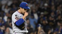 New York Mets pitcher Jonah Tong (21) reacts during the third inning against the Chicago Cubs at Wrigley Field.