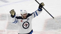 Winnipeg Jets center Jonathan Toews (19) acknowledges the crowd during the first period of his first game back at the United Center since leaving the Chicago Blackhawks.
