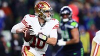 San Francisco 49ers quarterback Mac Jones (10) rolls out against the Seattle Seahawks during the second half in an NFC Divisional Round game at Lumen Field.