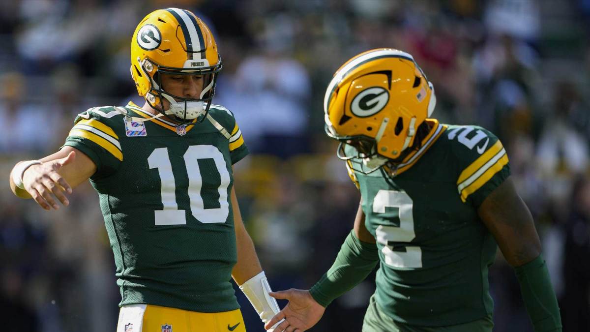 Green Bay Packers quarterback Jordan Love (10) greets quarterback Malik Willis (2) during warmups prior to the game against the Cincinnati Bengals at Lambeau Field.