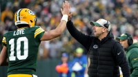 Green Bay Packers quarterback Jordan Love (10) high fives head coach Matt LaFleur after throwing a touchdown pass during the second quarter of their game against the Chicago Bear Sunday, January 7, 2024 at Lambeau Field in Green Bay, Wisconsin.