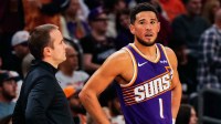 Phoenix Suns Head Coach Jordan Ott and Phoenix Suns guard Devin Booker (1) talk in the first half of the game at Mortgage Match Up Center.