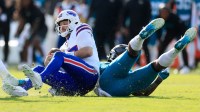 Buffalo Bills quarterback Josh Allen (17) is sacked by Jacksonville Jaguars defensive end Josh Hines-Allen (41) during the third quarter of an NFL football AFC Wild Card playoff matchup, Sunday, Jan. 11, 2026, in Jacksonville, Fla. The Bills defeated the Jaguars 27-24