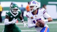 Buffalo Bills quarterback Josh Allen (17) rushes the ball past New York Jets linebacker Marcelino McCrary-Ball (41) during the first half at MetLife Stadium.