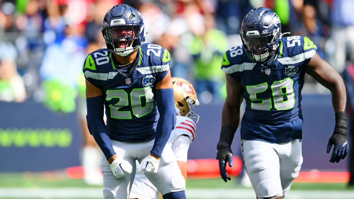 Seattle Seahawks linebacker Derick Hall (58) and Seattle Seahawks safety Julian Love (20) celebrate after a play during the first half against San Francisco 49ers at Lumen Field.