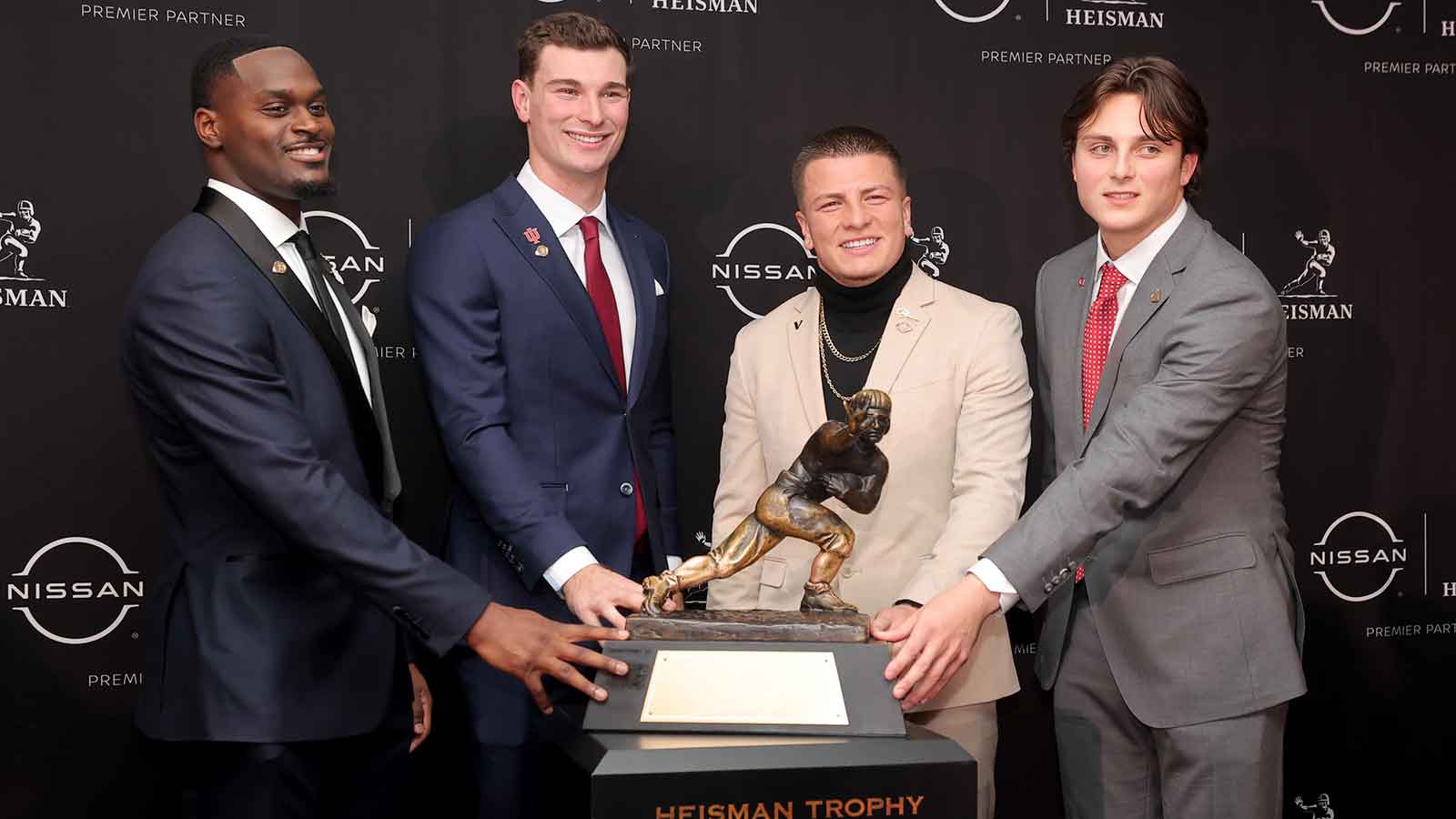 Notre Dame Fighting Irish running back Jeremiyah Love (left to right) and Indiana Hoosiers quarterback Fernando Mendoza and Vanderbilt Commodores quarterback Diego Pavia and Ohio State Buckeyes quarterback Julian Sayin pose with the Heisman trophy during a press conference at the New York Marriott Marquis.