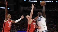Minnesota Timberwolves forward Julius Randle (30) passes against Houston Rockets center Alperen Sengun (28) and forward Jabari Smith Jr. (10) in the first quarter at Toyota Center.