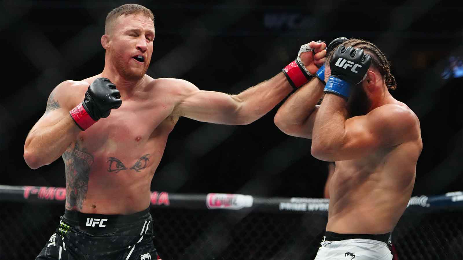 Justin Gaethje (red gloves) fights Rafael Fiziev (blue gloves) during UFC 313 at T-Mobile Arena.