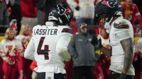 Houston Texans cornerback Kamari Lassiter (4) and Houston Texans safety Jalen Pitre (5) celebrate after an interception during the fourth quarter against the Kansas City Chiefs at GEHA Field at Arrowhead Stadium.