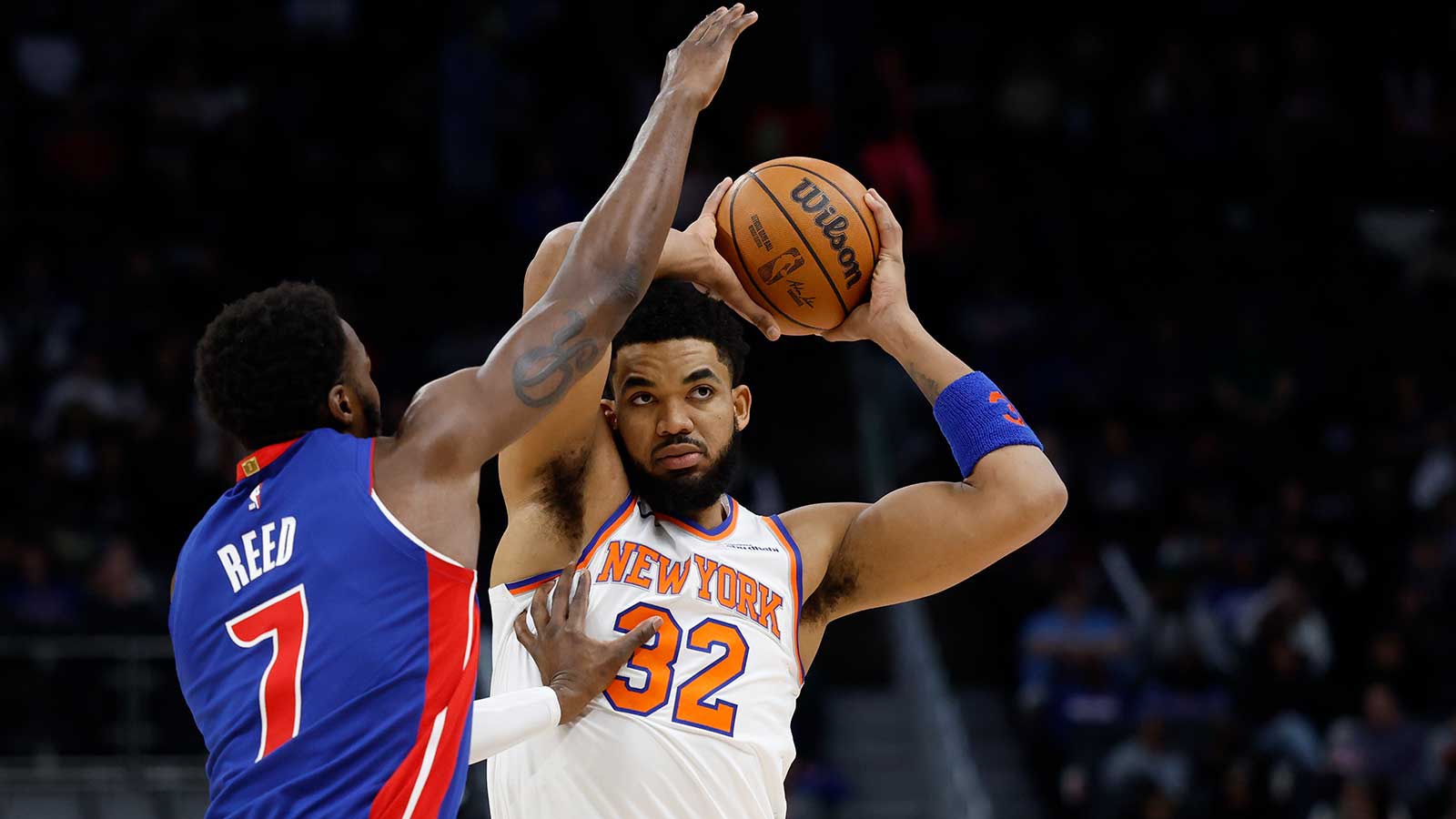New York Knicks center Karl-Anthony Towns (32) is defended by Detroit Pistons forward Paul Reed (7) in the first half at Little Caesars Arena.