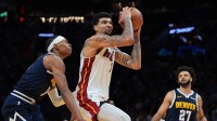 Miami Heat center Kel'El Ware (7) drives to the basket against Denver Nuggets guard Peyton Watson (8) during the third quarter at Kaseya Center.