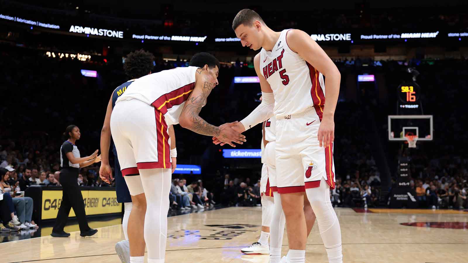 Miami Heat forward Nikola Jovic (5) and center Kel'El Ware (7) shake hands during the third quarter against the Denver Nuggets at Kaseya Center.