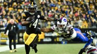 Pittsburgh Steelers running back Kenneth Gainwell (14) rushes as Buffalo Bills linebacker Dorian Williams (42) defends during the second quarter at Acrisure Stadium.