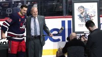 Winnipeg Jets right wing Nino Niederreiter (62) is presented his 100 NHL game silver hockey stick by Winnipeg Jets General manager Kevin Cheveldayoff before a game against the Washington Capitals at Canada Life Centre.
