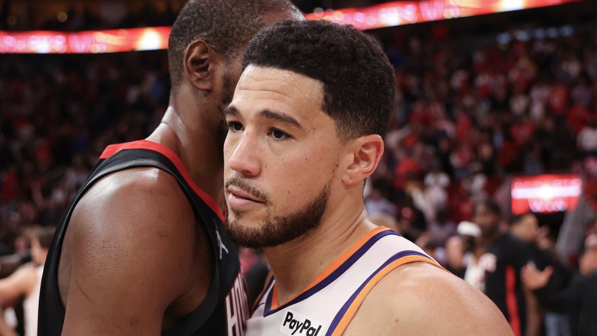 Houston Rockets forward Kevin Durant (7) hugs Phoenix Suns guard Devin Booker (1) after defeating the Phoenix Suns at Toyota Center.