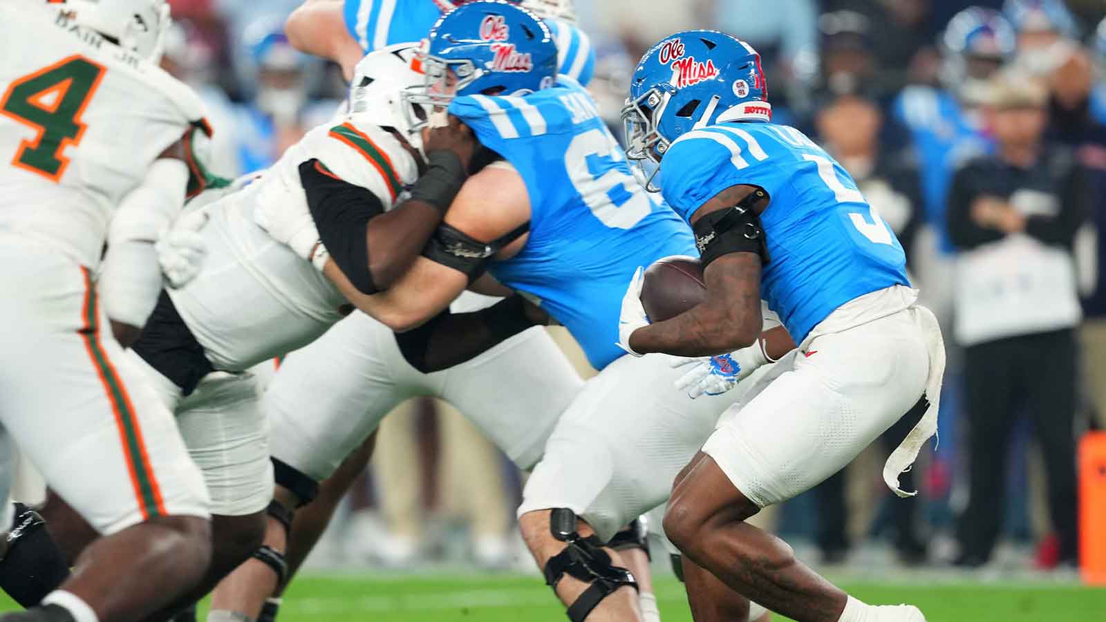 Mississippi Rebels running back Kewan Lacy (5) rushes the ball against the Miami Hurricanes in the first half during the 2026 Fiesta Bowl and semifinal game of the College Football Playoff at State Farm Stadium.