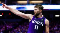 Kings forward Domantas Sabonis (11) reacts after a play during the fourth quarter against the Washington Wizards at Golden 1 Center with the Raptors in the background