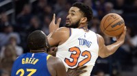 ew York Knicks center Karl-Anthony Towns (32) has the ball defended by Golden State Warriors forward Draymond Green (23) during the second quarter at Chase Center.