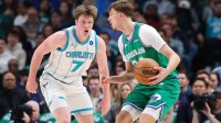 Dallas Mavericks forward Cooper Flagg (32) controls the ball as Charlotte Hornets guard Kon Knueppel (7) defends during the first quarter at American Airlines Center.