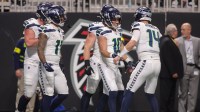 Seattle Seahawks wide receiver Cooper Kupp (10) celebrates with quarterback Sam Darnold (14) after a touchdown catch against the Atlanta Falcons in the fourth quarter at Mercedes-Benz Stadium.