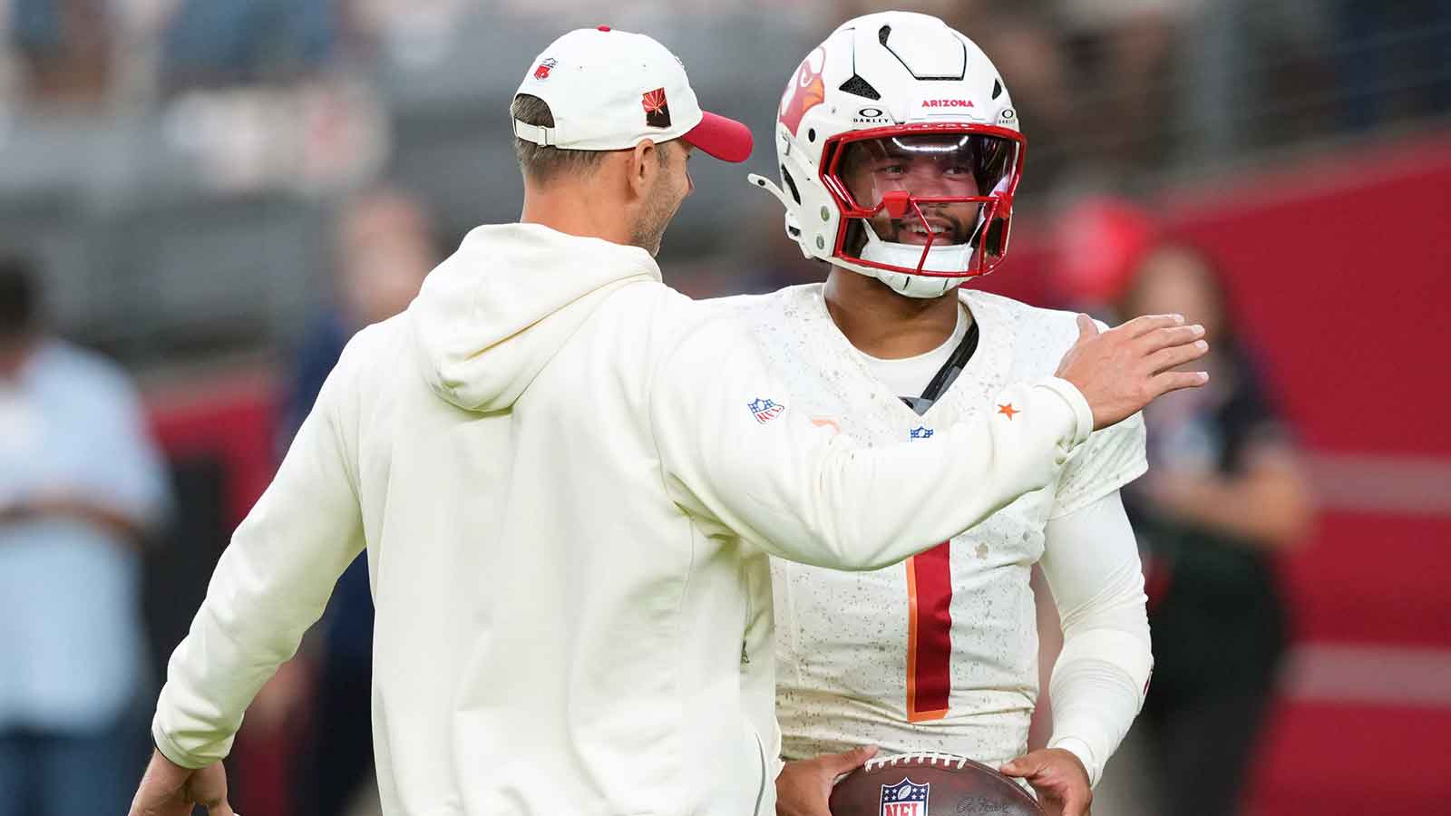Arizona Cardinals quarterback Kyler Murray (1) and head coach Jonathan Gannon talk before the game against the Seattle Seahawks at State Farm Stadium.