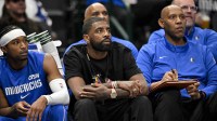 Dallas Mavericks guard Kyrie Irving (center) looks on from the team bench during the first quarter against the Brooklyn Nets at the American Airlines Center.