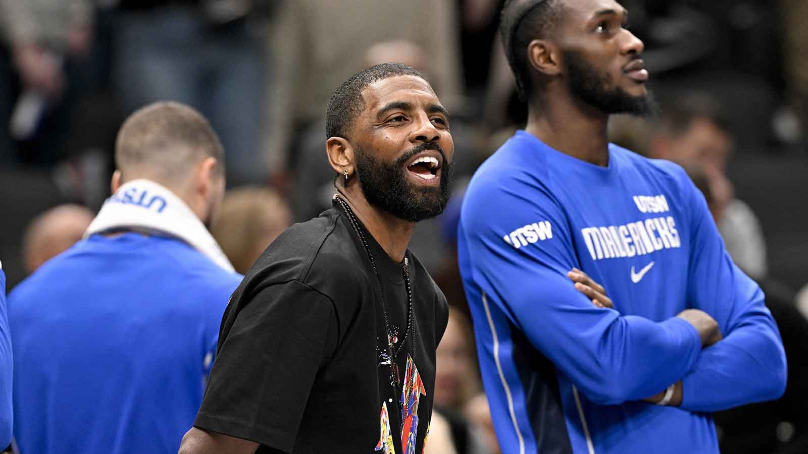 Dallas Mavericks guard Kyrie Irving (11) jokes with his teammates during the second half against the Brooklyn Nets at the American Airlines Center.