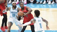 Toronto Raptors forward RJ Barrett (9) looks to pass as he is defended by Charlotte Hornets forward Miles Bridges (0) and guard LaMelo Ball (1) during the first half at the Spectrum Center. Mandatory Credit: Sam Sharpe-Imagn Images