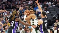 Milwaukee Bucks forward Giannis Antetokounmpo (center) is defended by Sacramento Kings guard Keon Ellis (left) and guard Zach LaVine (8) during the second quarter at Golden 1 Center.