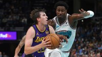 Lakers guard Austin Reaves (15) drives to the basket as Memphis Grizzlies forward Jaren Jackson Jr. (13) defends during the first half at FedExForum