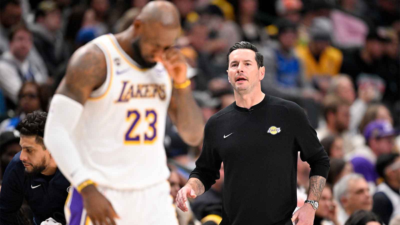 Lakers forward LeBron James (23) walks back on the court in front of head coach JJ Redick during the second quarter against the Dallas Mavericks at the American Airlines Center