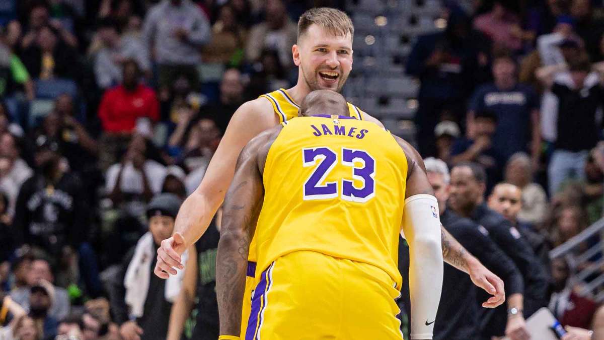 Lakers' LeBron James (23) jokes with Luka Doncic