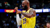 Lakers forward LeBron James (23) gestures before the game against the Denver Nuggets at Ball Arena with Lakers' Jeanie Buss and Chris Haynes in the background