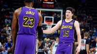 Los Angeles Lakers guard Austin Reaves (15) reacts with forward LeBron James (23) during the second quarter against the Memphis Grizzlies at FedExForum.