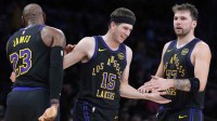Lakers guard Austin Reaves (15) is congratulated by Luka Doncic