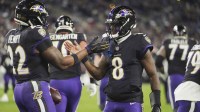 Baltimore Ravens quarterback Lamar Jackson (8) congratulates running back Derrick Henry (22) on a touchdown run against the New England Patriots during the first quarter at M&T Bank Stadium.