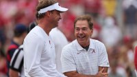 Ole Miss Rebels head coach Lane Kiffin talks with Alabama Crimson Tide head coach Nick Saban before the start of an NCAA college football game at Bryant-Denny Stadium.