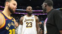 Los Angeles Lakers forward LeBron James (23) talks with Golden State Warriors guard Stephen Curry (30) and forward Draymond Green (right) after the game at Chase Center.